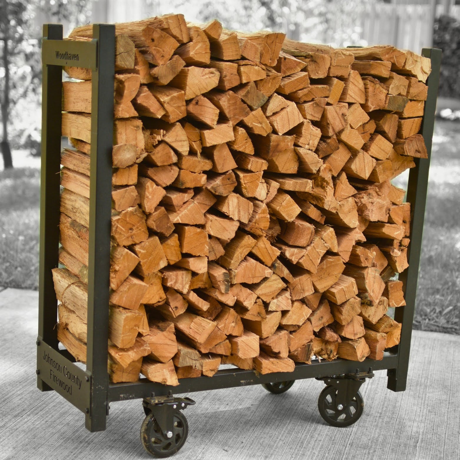 Kiln-dried oak firewood stacked on portable wheeled rack — Johnson County Firewood